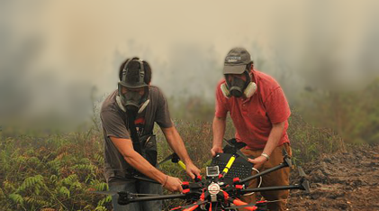 Scientists carrying a UAV away from a wildfire