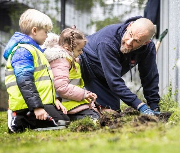 Children weeding at Space Park Leicester for Earth Day 2024