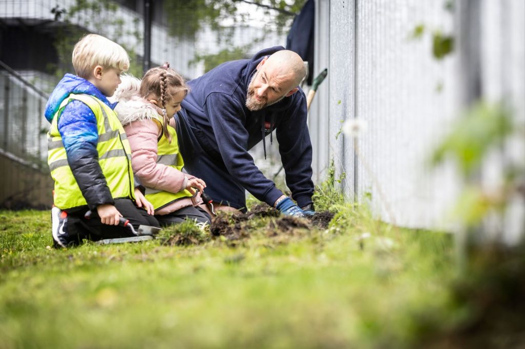 Children weeding at Space Park Leicester for Earth Day 2024